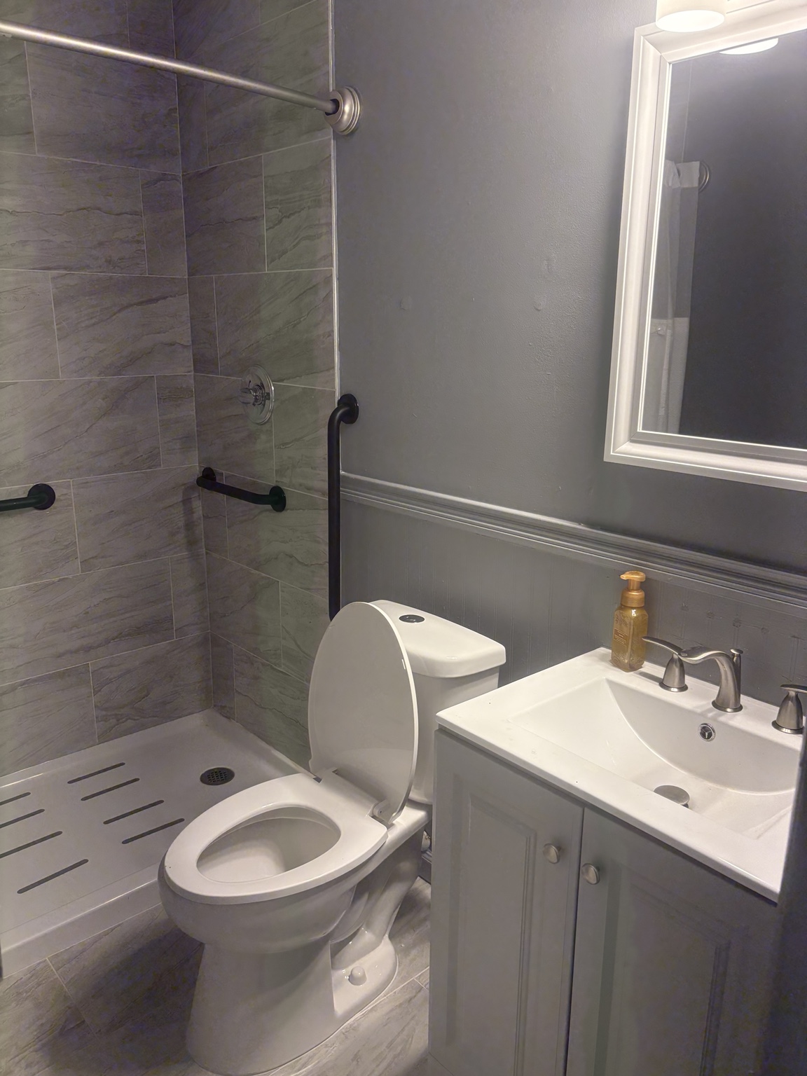 Bathroom with walk-in shower and grab bars